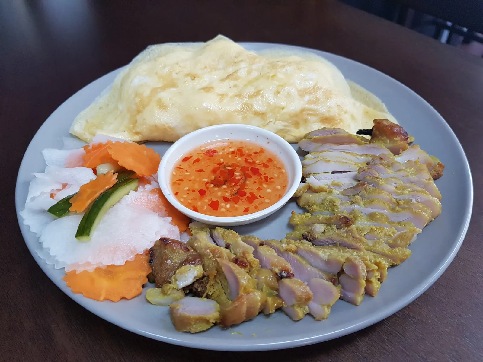 Tyron's Special — folded omelette with turmeric grilled chicken, pickled vegetables and chili sauce